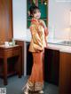 A woman standing in a kitchen next to a counter.