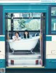 A couple of women sitting in a bathtub on a bus.