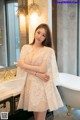 A woman standing in front of a bathtub in a bathroom.